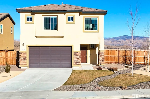 view of front facade featuring a mountain view and a garage