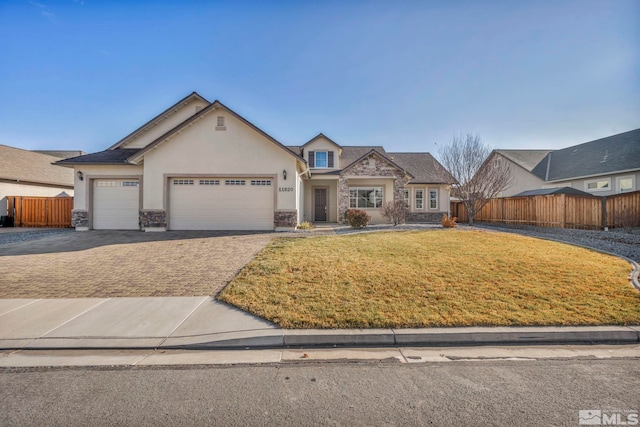 view of front of house featuring a garage and a front lawn