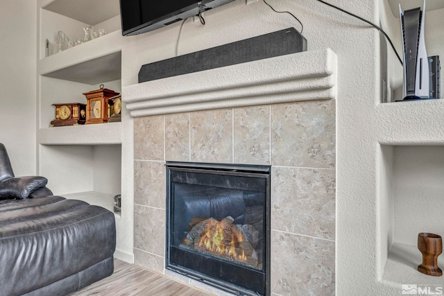 room details with hardwood / wood-style flooring and a fireplace