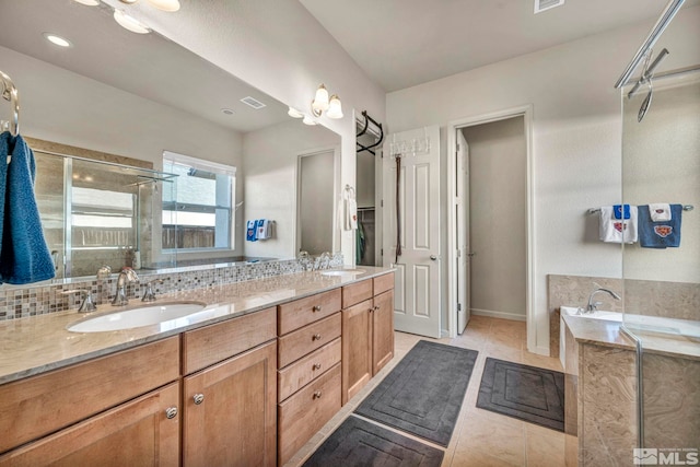 bathroom featuring tile patterned floors, tasteful backsplash, vanity, and independent shower and bath