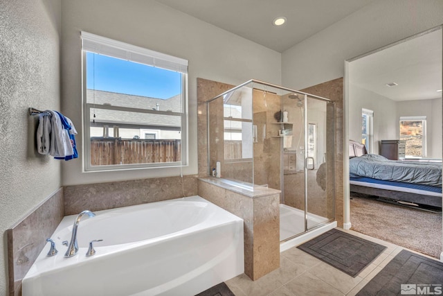 bathroom with tile patterned floors, a healthy amount of sunlight, and shower with separate bathtub