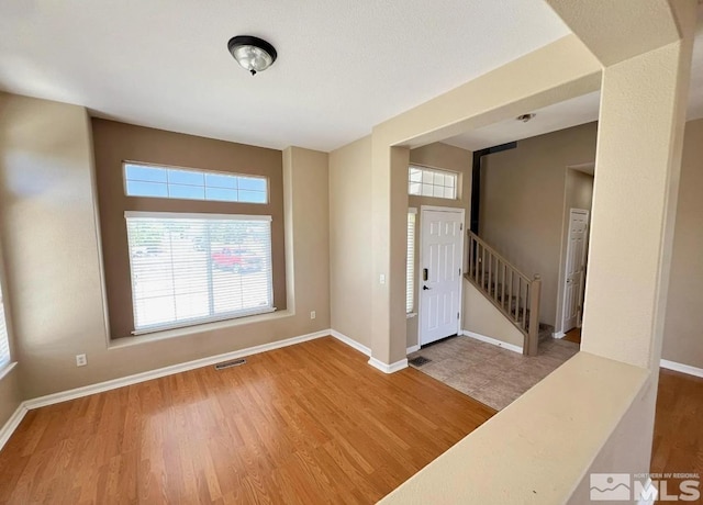 entryway with hardwood / wood-style floors