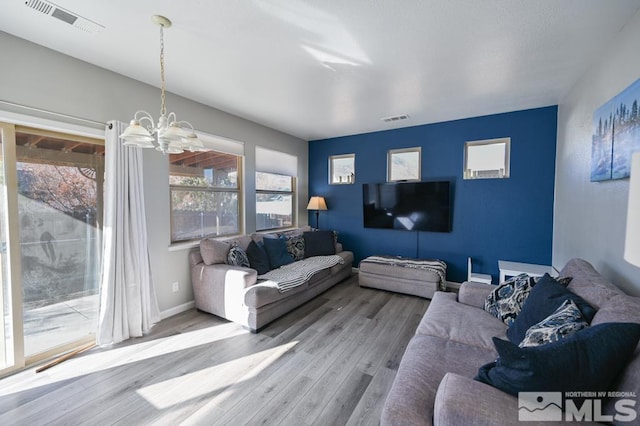 living room with a chandelier and hardwood / wood-style flooring