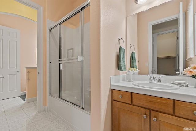 bathroom featuring vanity, tile patterned floors, and shower / bath combination with glass door