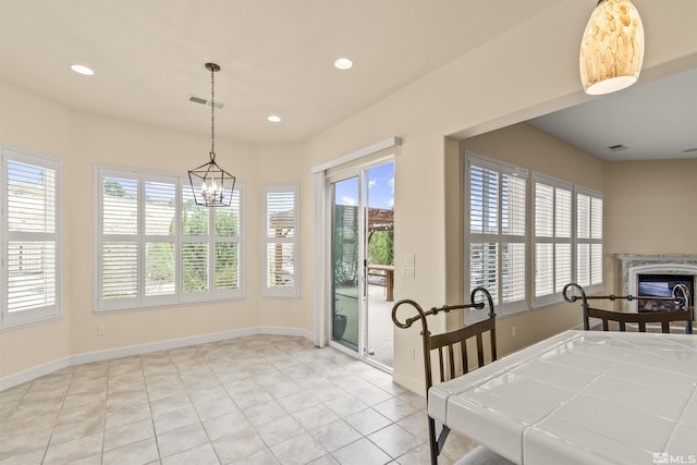 tiled dining space featuring a chandelier