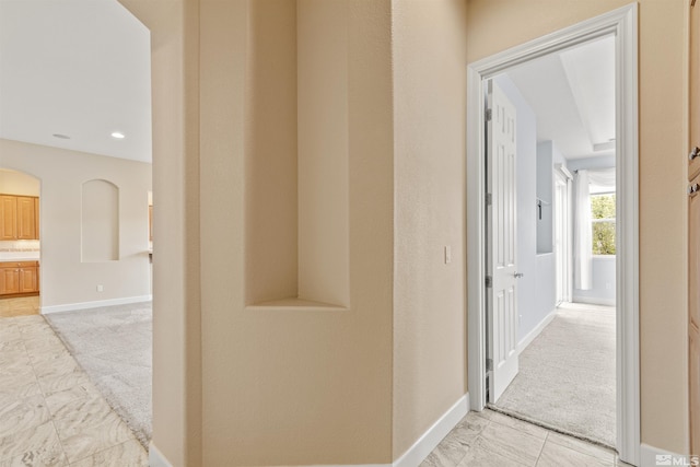 hallway with light colored carpet