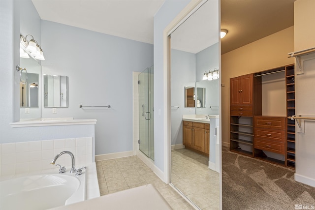 bathroom with vanity, shower with separate bathtub, and tile patterned flooring