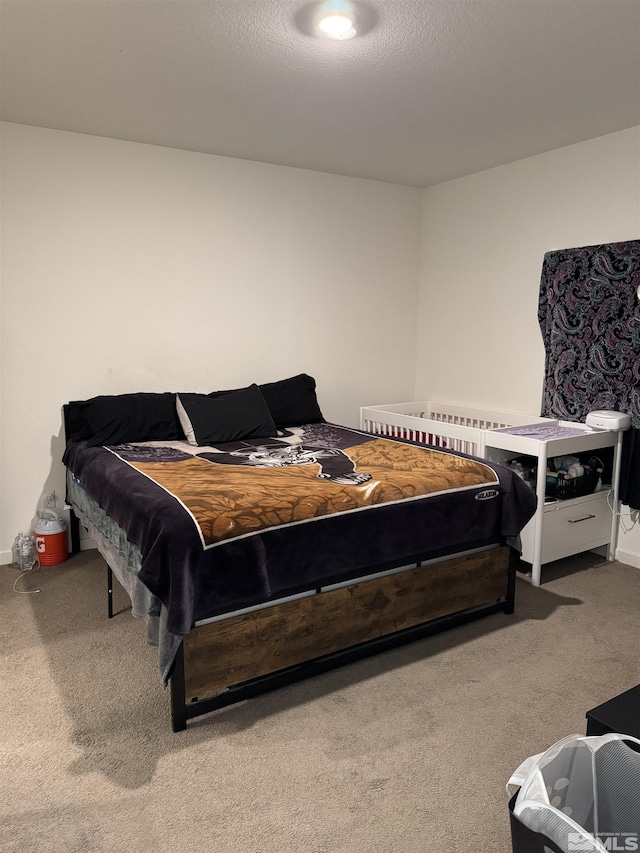 bedroom featuring a textured ceiling and carpet floors