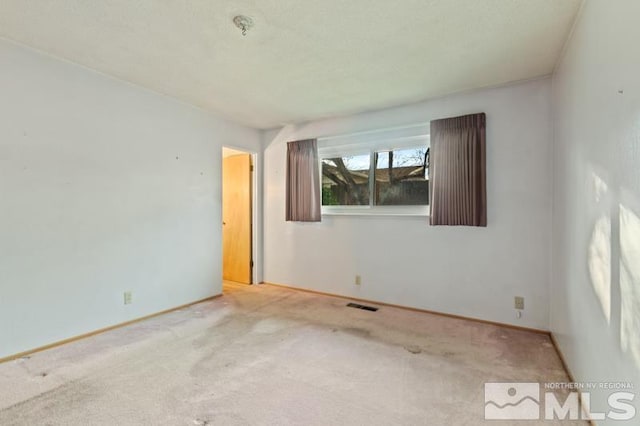 unfurnished room with light colored carpet