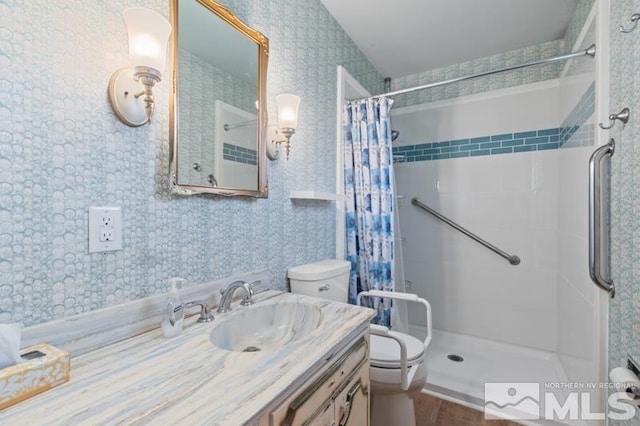 bathroom featuring curtained shower, vanity, wood-type flooring, and toilet