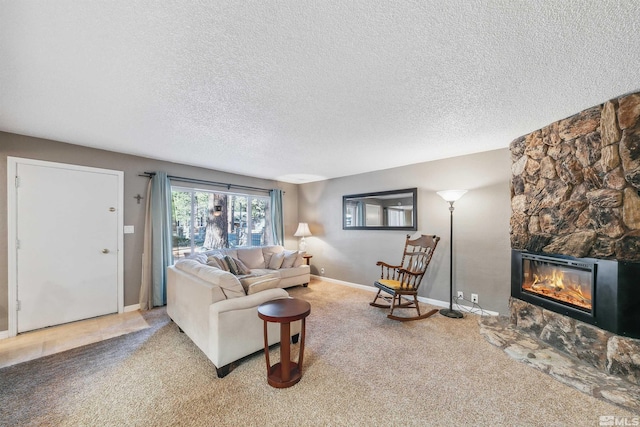 living room with a stone fireplace, light colored carpet, and a textured ceiling