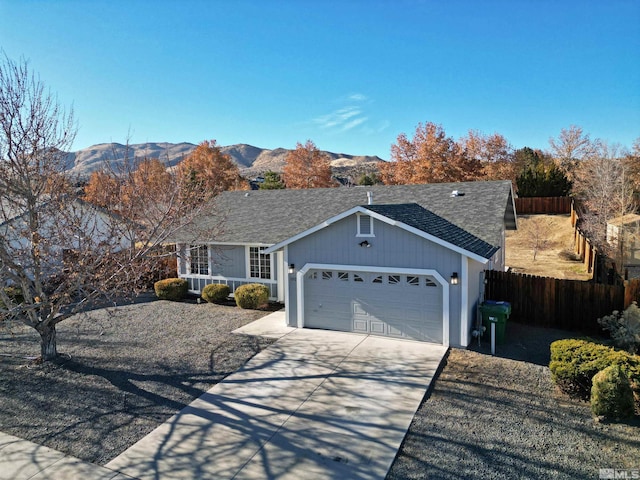 single story home with a mountain view and a garage