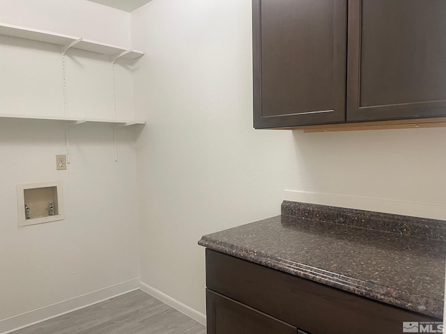 laundry area featuring hardwood / wood-style flooring, cabinets, and hookup for a washing machine