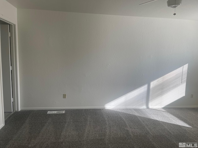 carpeted empty room featuring ceiling fan