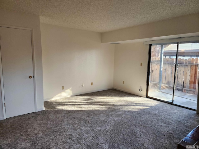 empty room featuring carpet floors and a textured ceiling