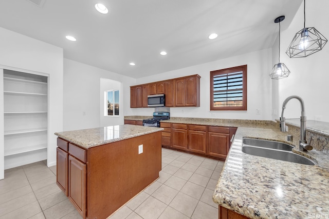 kitchen with pendant lighting, a center island, stainless steel appliances, and sink