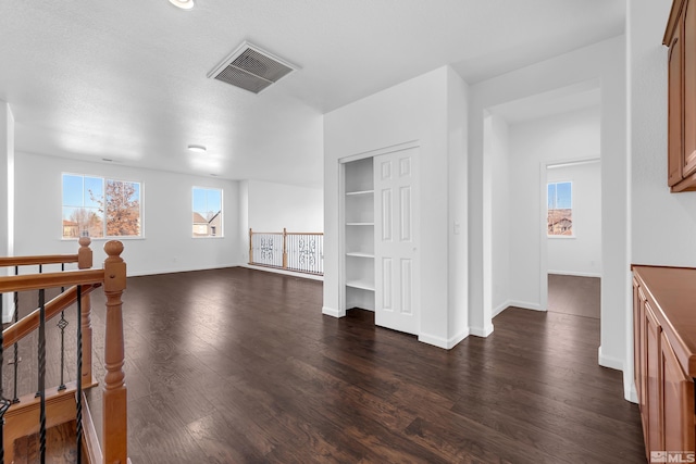 interior space with dark hardwood / wood-style floors and a textured ceiling