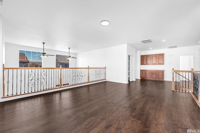 spare room with ceiling fan and dark hardwood / wood-style flooring