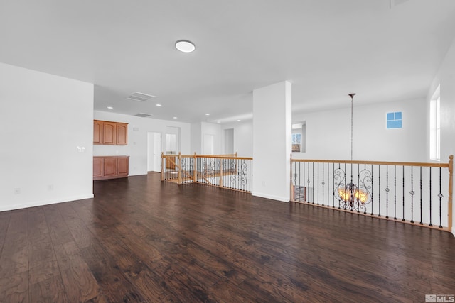 unfurnished living room with dark hardwood / wood-style flooring