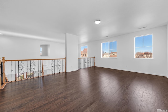 spare room with dark hardwood / wood-style flooring