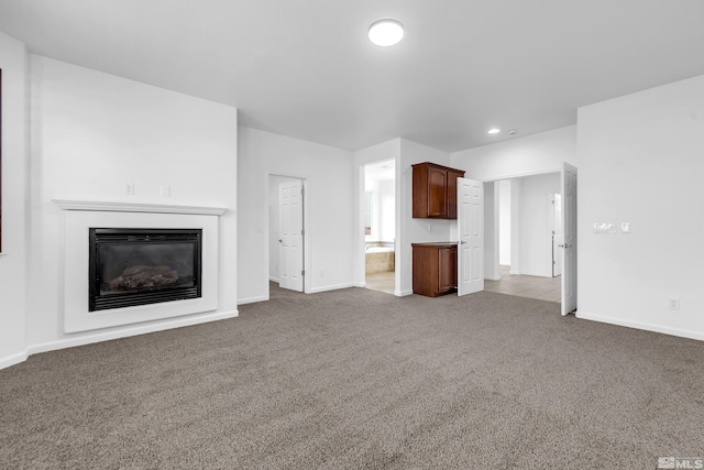 unfurnished living room featuring light carpet