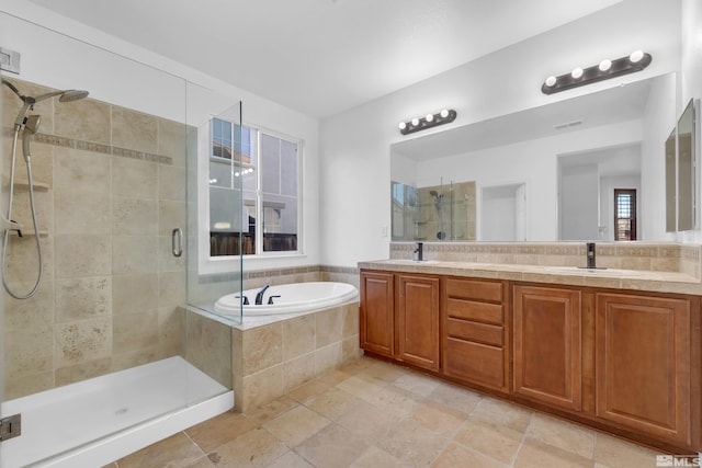 bathroom featuring vanity and independent shower and bath