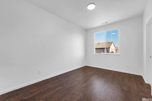 spare room featuring dark hardwood / wood-style flooring