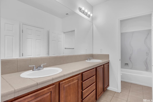 bathroom featuring tile patterned floors, shower / tub combination, and vanity