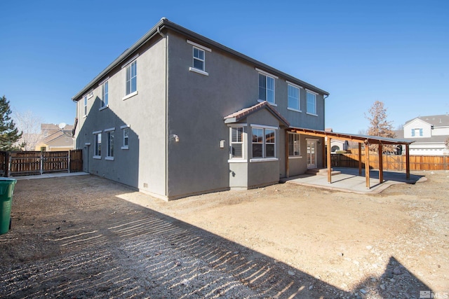 back of property with a patio