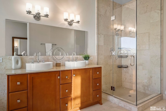 bathroom featuring tile patterned floors, vanity, and a shower with door