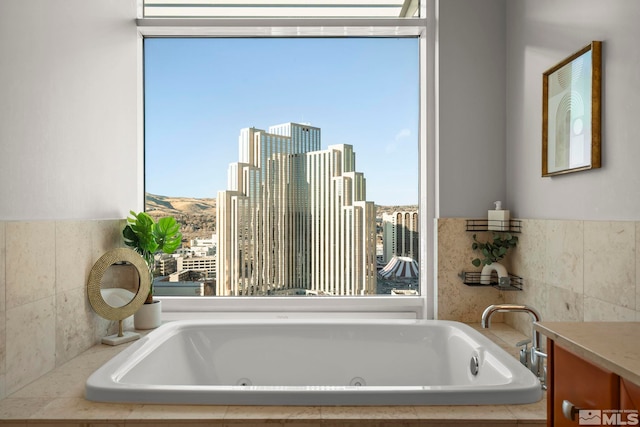 bathroom with plenty of natural light and tiled tub