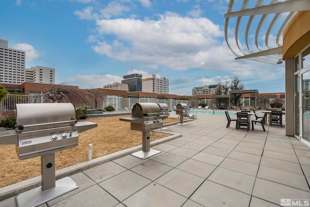 view of patio with a community pool and a grill