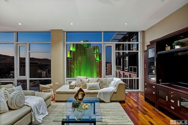 living room with hardwood / wood-style floors and floor to ceiling windows