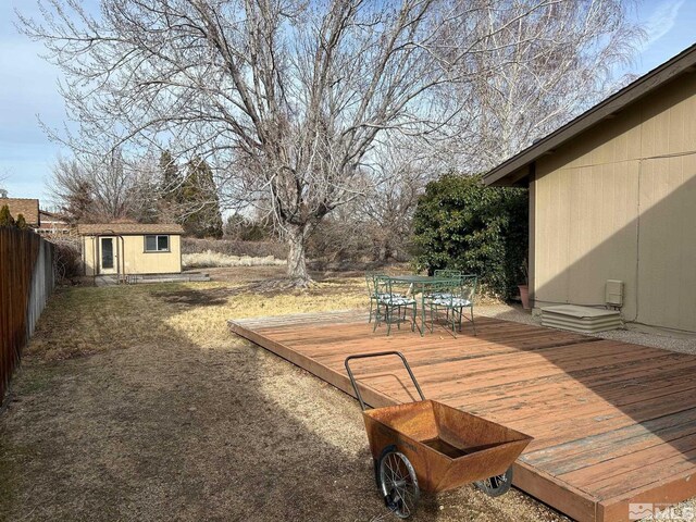 view of yard with a shed and a wooden deck