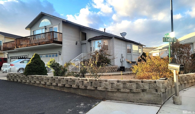 view of front of home with a balcony and a garage