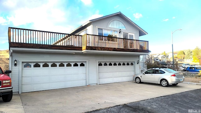 view of front of house featuring a garage and a balcony