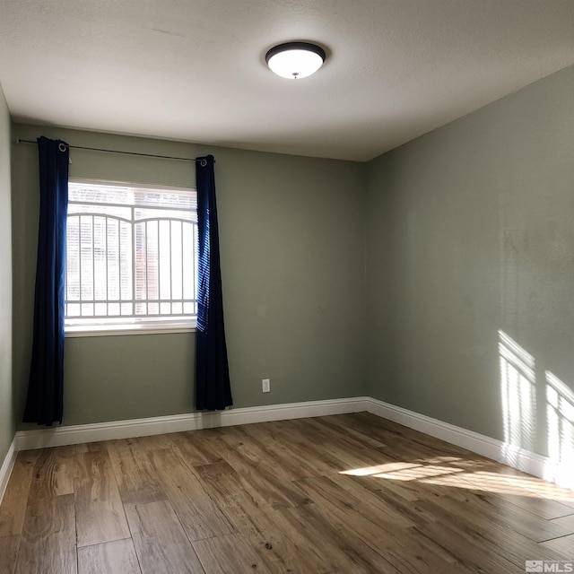 empty room with hardwood / wood-style flooring