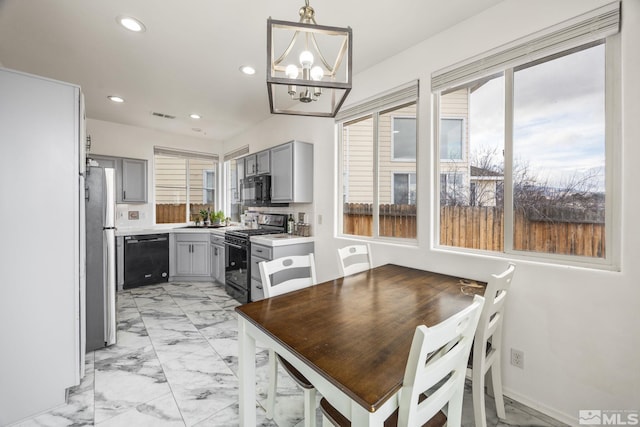 dining area featuring sink and a chandelier