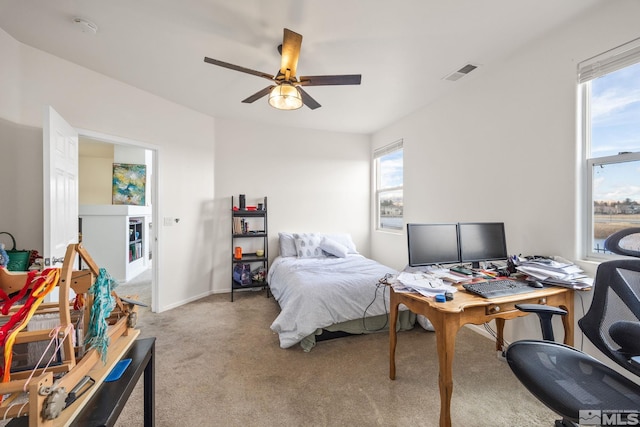 carpeted bedroom with multiple windows and ceiling fan