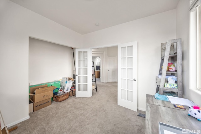 interior space with french doors and light colored carpet