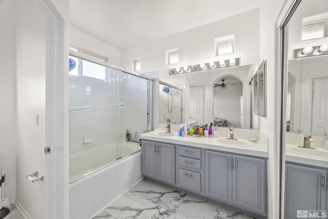 bathroom featuring ceiling fan, vanity, and combined bath / shower with glass door