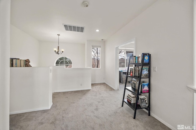 interior space with light carpet and an inviting chandelier