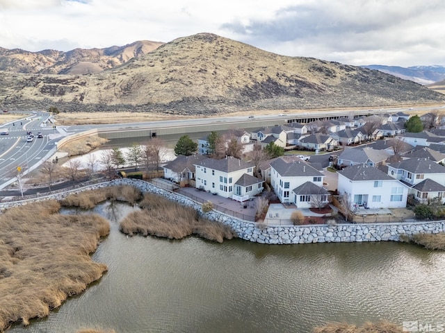 bird's eye view with a water and mountain view