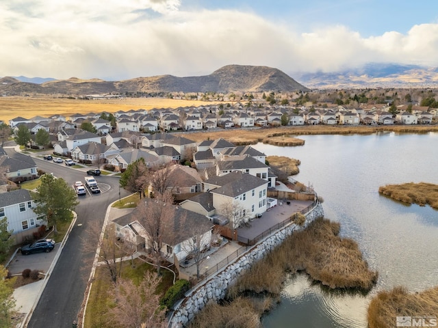 aerial view featuring a water and mountain view