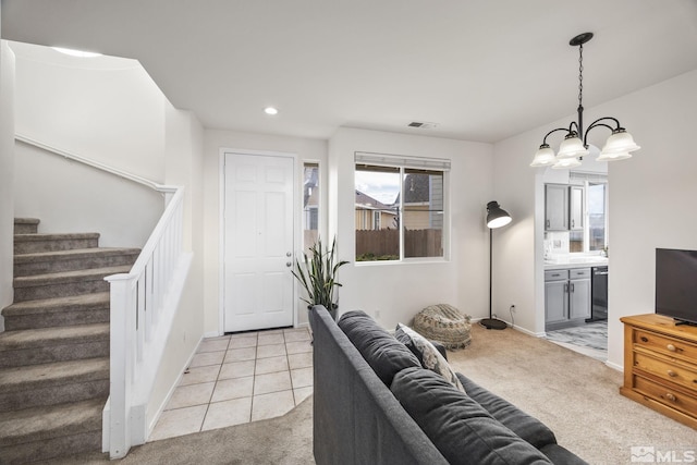 carpeted living room featuring an inviting chandelier