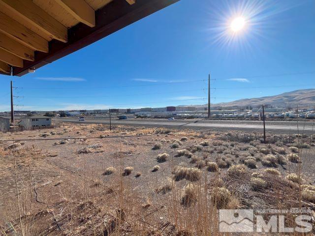 view of yard with a mountain view and a rural view