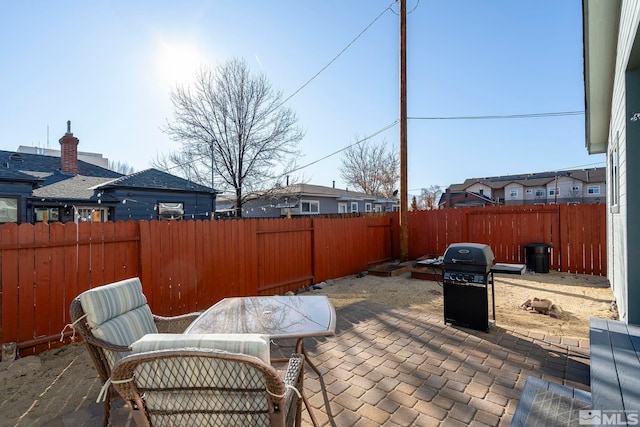 view of patio featuring a grill