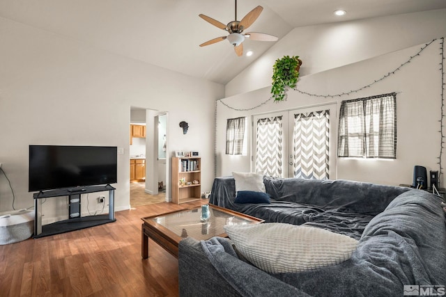 living room featuring hardwood / wood-style flooring, plenty of natural light, ceiling fan, and high vaulted ceiling