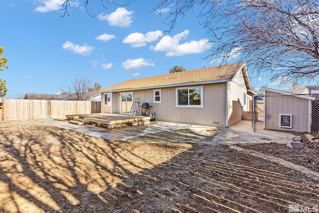 back of property with a patio area and a storage unit