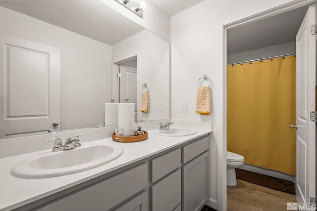 bathroom featuring a shower with curtain, vanity, toilet, and hardwood / wood-style floors